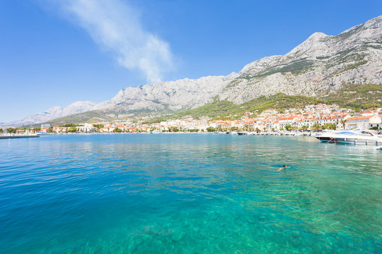 Makarska, Dalmatia, Croatia - A woman swimming in the bay of Makarska
