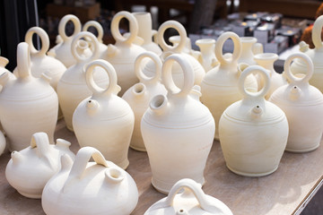 Close-up background of white clay jugs, traditional Spanish home utensils.
