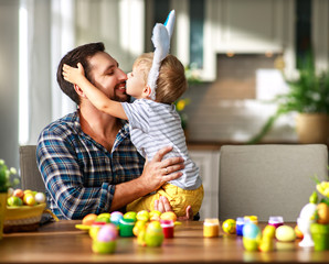 Happy easter! family father and child with ears hare getting ready for holiday