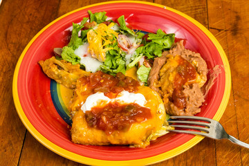 Chimichanga Mexican Dinner with Refired Beans and Salad on Colorful Plate