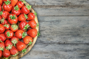 Strawberries on a plate on a wooden table