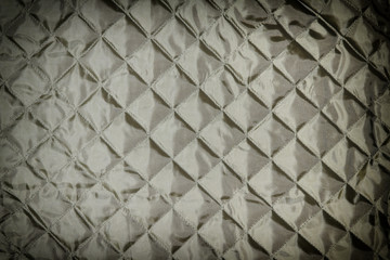 Texture, black quilted fabric close up. Blank background for layouts.