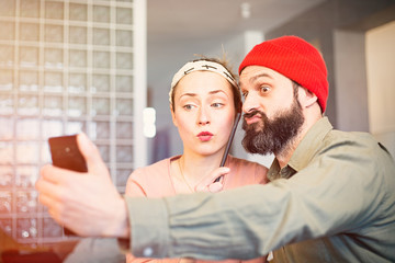 Happy young couple taking selfie photo at home. Romantic relationship between people