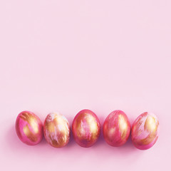 Pink easter eggs with striped golden paint