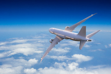 Passengers commercial airplane flying above clouds