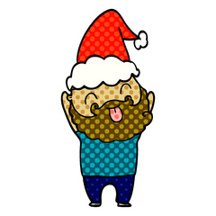 man with beard sticking out tongue wearing santa hat