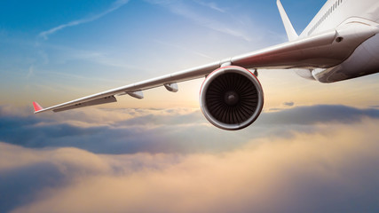 Commercial jet airplane flying above clouds