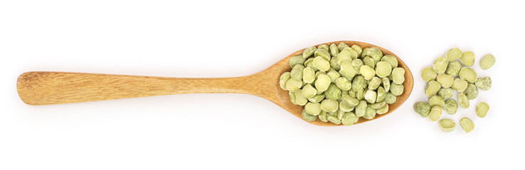 Green split peas in a wooden spoon isolated on white background. Top view