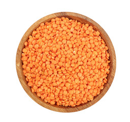 red lentil in wooden bowl isolated on white background. Top view
