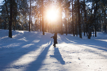 Girl whirls in the winter forest