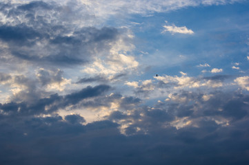 Landscape with dramatic light - beautiful golden sunset with saturated sky and clouds.