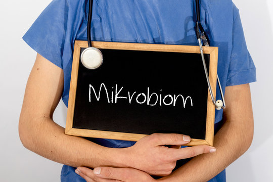 Doctor shows information on blackboard: Mikrobion.  Medical concept.