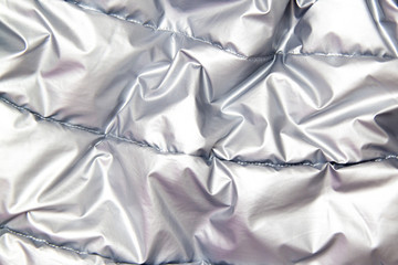 Obraz premium textile and texture concept - close up of crumpled gray silver metallic fabric background.