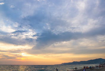 Amazing sea sunset on the pebble beach, the sun, waves, clouds