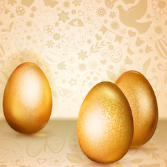 Three golden Easter eggs standing on background of flowers, cakes, hare, chicken and other holiday symbols