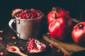 Metal rustic mug full of pomegranate seeds