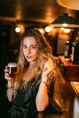 Young woman enjoys a beer