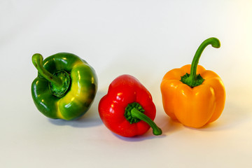 Three isolated fresh colorful peppers