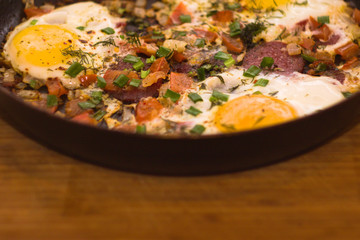 Scrambled eggs in a pan on a wood Board