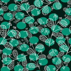 floral ornament drawn in white on a dark background on green dots 