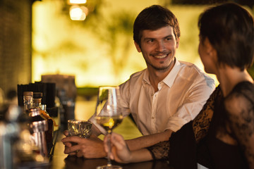 Young couple enjoying romantic date at the bar
