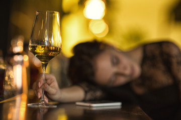 Drunk woman sleeping at the bar