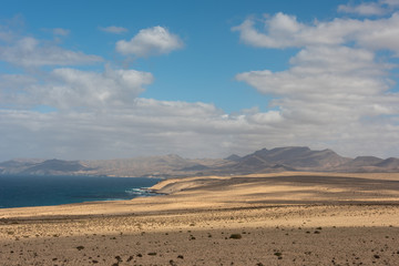 Fototapeta na wymiar Barlovento desert, Costa Calma, Canary Islands, Spain. High hills by the ocean shore. 