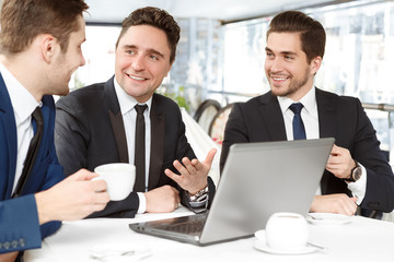 Fototapeta premium Always pleasure to work with professionals. Businessmen enjoying lunch in a local restaurant