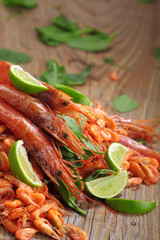 Pile of shrimp on wooden table.Shrimps.Raw fresh big shrimps with lime .