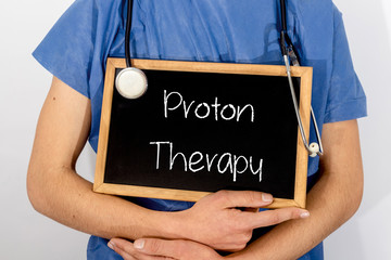 Doctor shows information on blackboard: proton therapy.  Medical concept.
