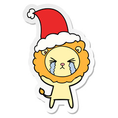 sticker cartoon of a crying lion wearing santa hat