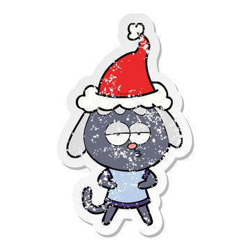 distressed sticker cartoon of a bored dog wearing santa hat