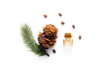 Cedar oil Bottles with pine oil and pine nuts, isolated on a white background - 252730462