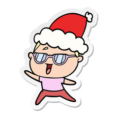 sticker cartoon of a happy woman wearing spectacles wearing santa hat