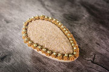 Chocolate egg filled with Brazilian sweet cream and sweet milk for Easter on wooden background