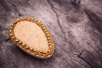 Chocolate egg filled with Brazilian sweet cream and sweet milk for Easter on wooden background