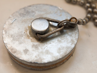 close up of bath plug rusty grimy old used dirty metal