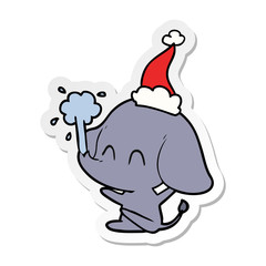 cute sticker cartoon of a elephant spouting water wearing santa hat