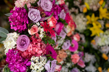 Big colorful flowers arrangement in pink tones at a florist shop, beautiful crown shaped decorative floral arrangement. Spring concept.