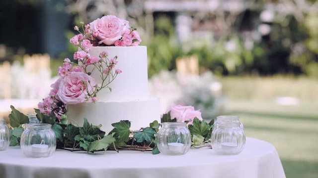 Dolly shot White wedding cake with flowers