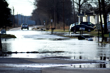 Flood waters spread across city roads
