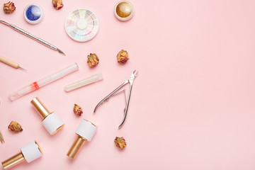 A set of cosmetic tools for manicure and pedicure on a pink background. Gel polishes, nail files and nippers and top view. Composition for a card with a place for the text, Flat-lay