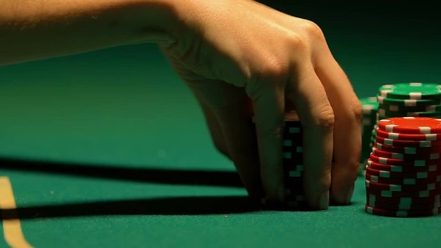 Lady putting poker chip rows on table, casino bet, chance of win and fortune