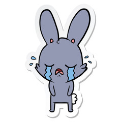 Fototapeta na wymiar sticker of a cute cartoon rabbit crying
