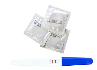 Pregnancy test and condom isolated on white background