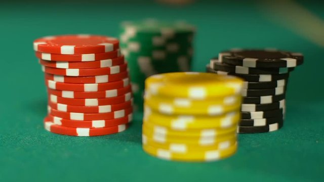 Poker players putting chips on table, making bet in casino, gambling addiction