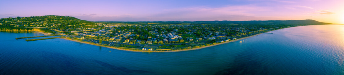 Fototapeta premium 180 aerial panorama of Safety Beach Suburb coastline at sunset. Mornington Peninsula, Victoria, Australia