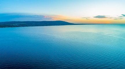 Aerial panorama of coastline hill and sea at sunset with copy space