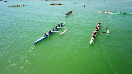 Aerial over outrigger canoes racing in a rowing race on the Pacific ocean near Ventura, California.