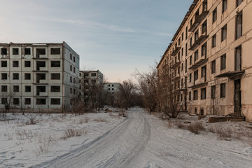 yard with the road among the abandoned houses
